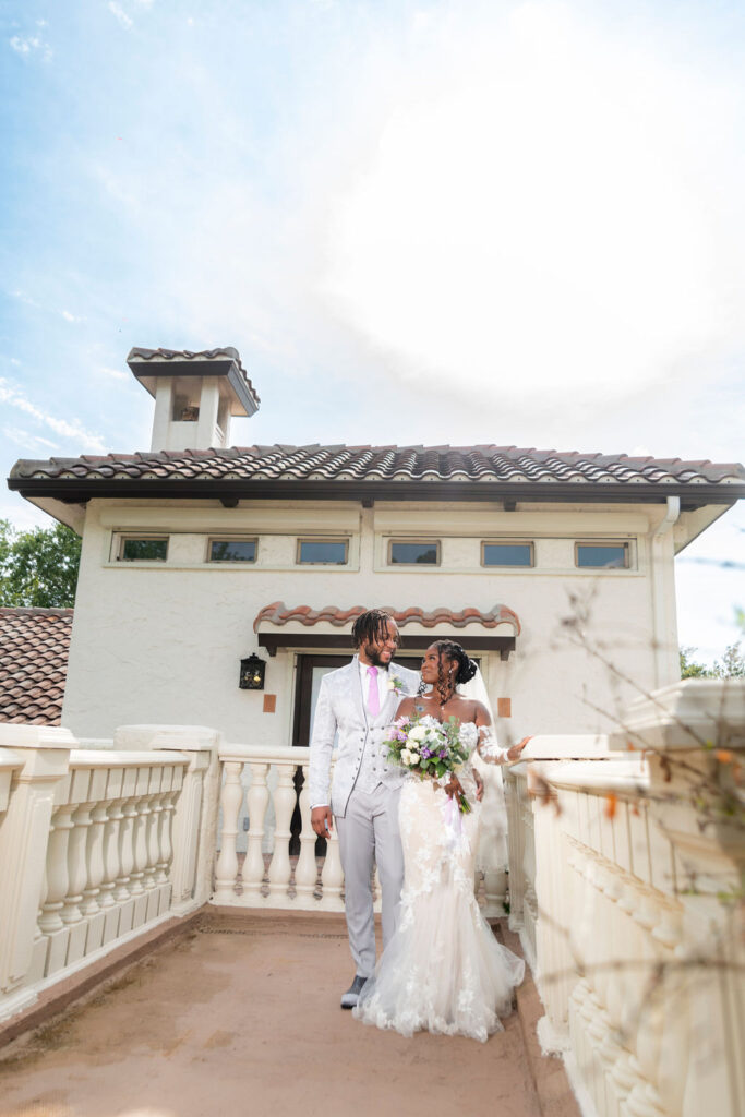 A couple enjoying the golden hour in the portico at Bonita Ranch, a wedding venue in Melbourne, Florida, with beautiful lighting and elegant architecture.
