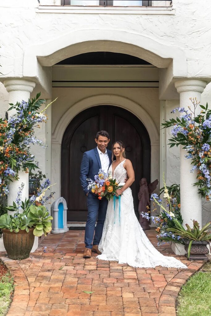 Couple exchanging vows in front of the Mediterranean-style Villa at Bonita Ranch, Melbourne, Florida.